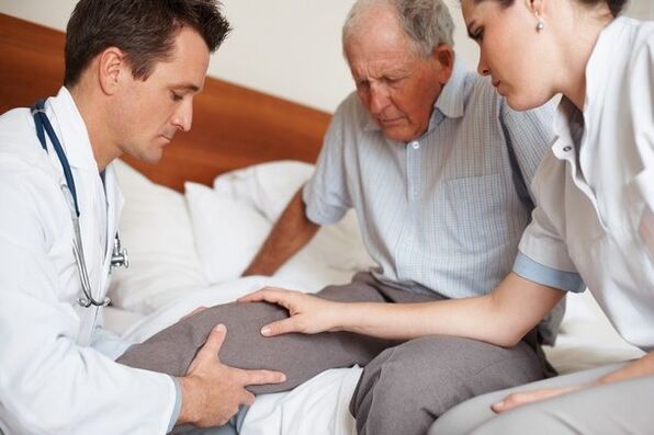 Médico examinando o joelho do paciente